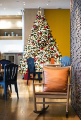 wooden rocking chair with orange scatter cushion in living room