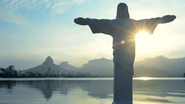 Christ statue souvenir standing in front of scenic sunset skyline view of Lagoa lagoon in Rio de Janeiro Brazil