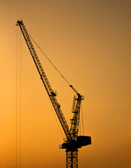 Silhouette of tower crane for construction site at sunset