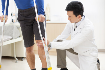 Doctor examining patient's leg