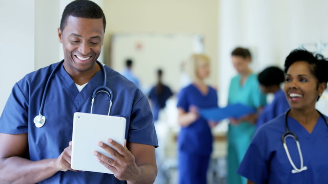 Portrait of African American male staff working on technology in medical center