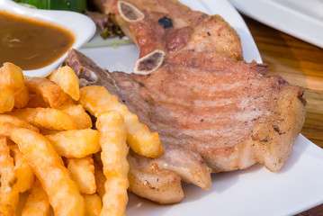 French Fries and Steak Pork Chop with mushroom mustard sauce.