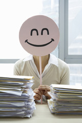Businesswoman With Smiley-Face Sign