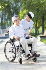 Nurse with wheelchair bound patient