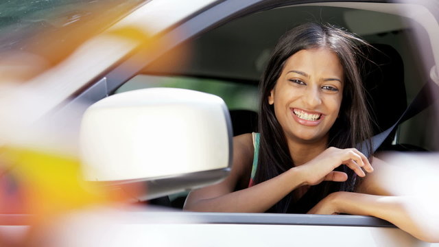 Portrait of young confident Indian American woman with car insurance