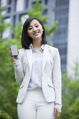 Portrait of young businesswoman with mobile phone