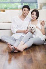 Cheerful young couple and a cute dog