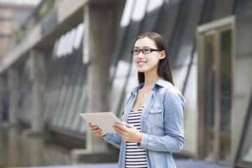 Young woman holding a digital tablet