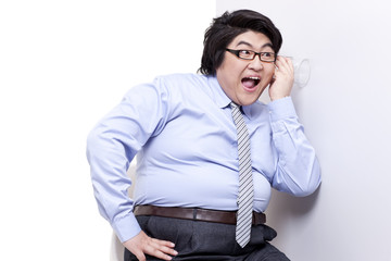Overweight businessman doing eavesdropping