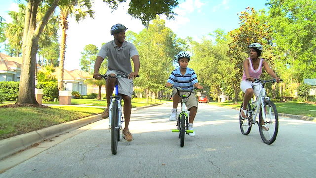fitness exercise lifestyle cycling African American parents son healthy living