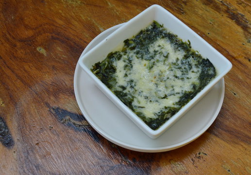 spinach with cheese in square bowl