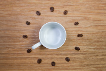 Empty coffee cup and clock of coffee beans