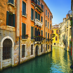 Venice sunset in water canal and traditional buildings. Italy