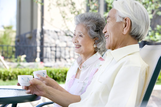Senior couple chatting and having tea