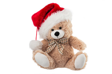 Fluffy teddy bear with Christmas hat isolated on white