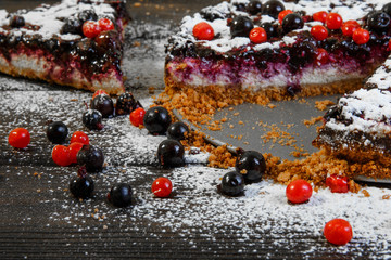 Berries near the cake on the wood background