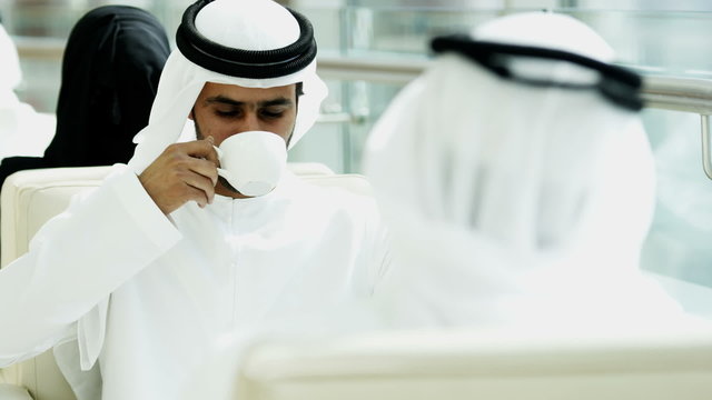 male Emirati clothing hotel atrium coffee relaxation travel tourism