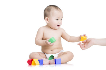 Fototapeta na wymiar Cute baby boy playing building blocks