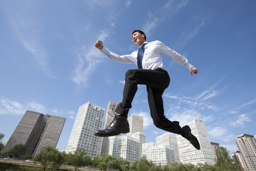 Fototapeta na wymiar Excited Businessman Jumping