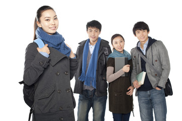 Female student smiling in the foreground with her friends smiling the background, white background