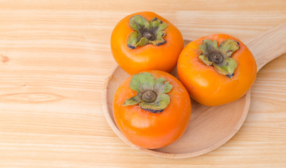 Persimmon on wood plate