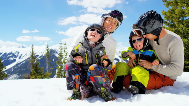 young Caucasian parents sons outdoor snow ski recreation active teamwork park