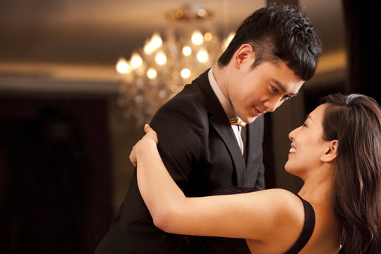Young couple dancing in a luxurious room