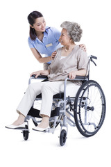 Fototapeta na wymiar Female nursing assistant taking care of senior in wheelchair