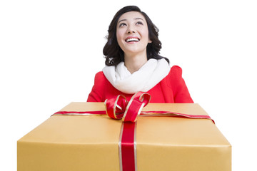Happy young woman holding a large gift