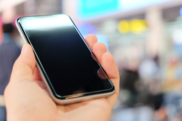 Close up of using smart phone at the airport.