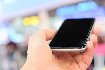 Close up of using smart phone at the airport.