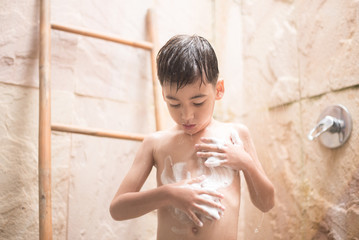 Little boy taking shower