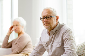 senior couple sitting on sofa at home