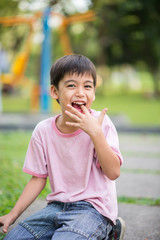 Fototapeta premium Little boy smiling in the park in summer time