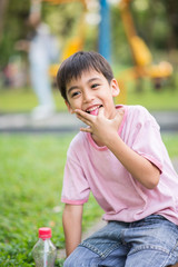 Fototapeta premium Little boy smiling in the park in summer time