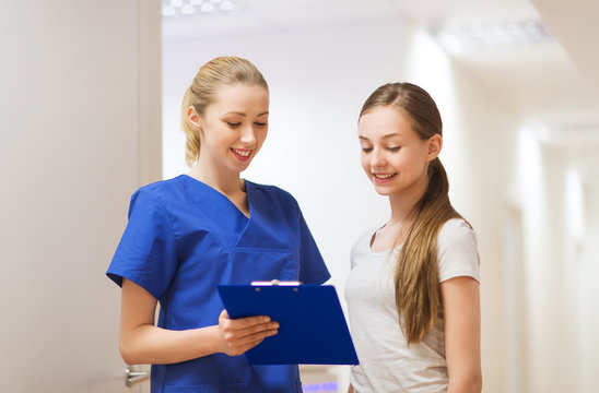 doctor or nurse with clipboard and girl patient