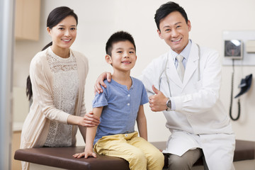 Doctor with boy and young woman in examination room