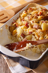French tartiflette potatoes with bacon and cheese close up 
