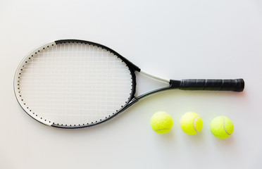 close up of tennis racket with balls