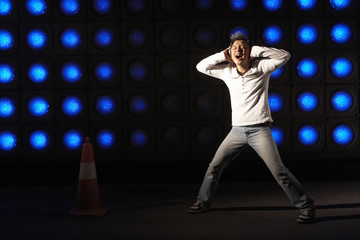 Obraz premium Young Man Performing On Illuminated Stage