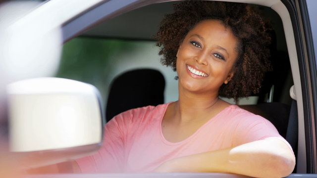 Portrait of young happy African American female buying new car