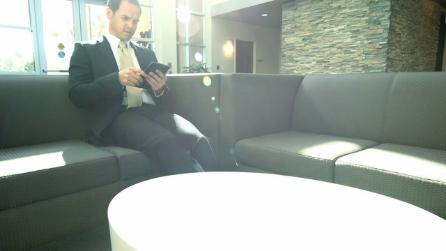 Male Caucasian business manager using office tablet technology
