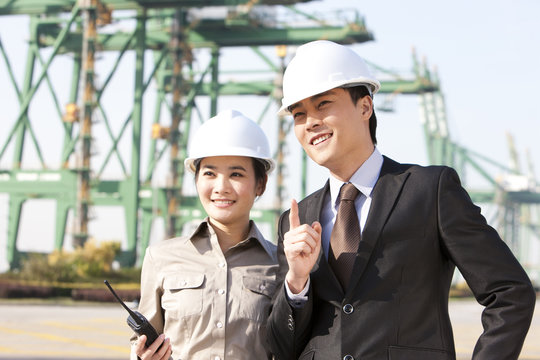 businessman with shipping industry worker in discussion