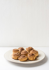 Cinnamon rolls on the wooden background