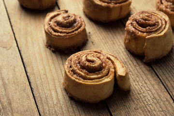 Cinnamon rolls on the wooden background
