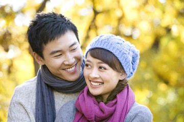 Young couple in park in Autumn