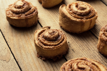 Cinnamon rolls on the wooden background