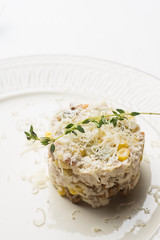 Chicken salad with cheese served on the beige plate