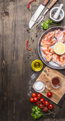 raw chicken wings in barbecue sauce in a pan with vegetables, spices on wooden rustic background top view close up