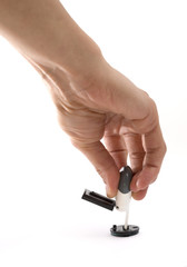 Plastic stamp in hand, isolated on white